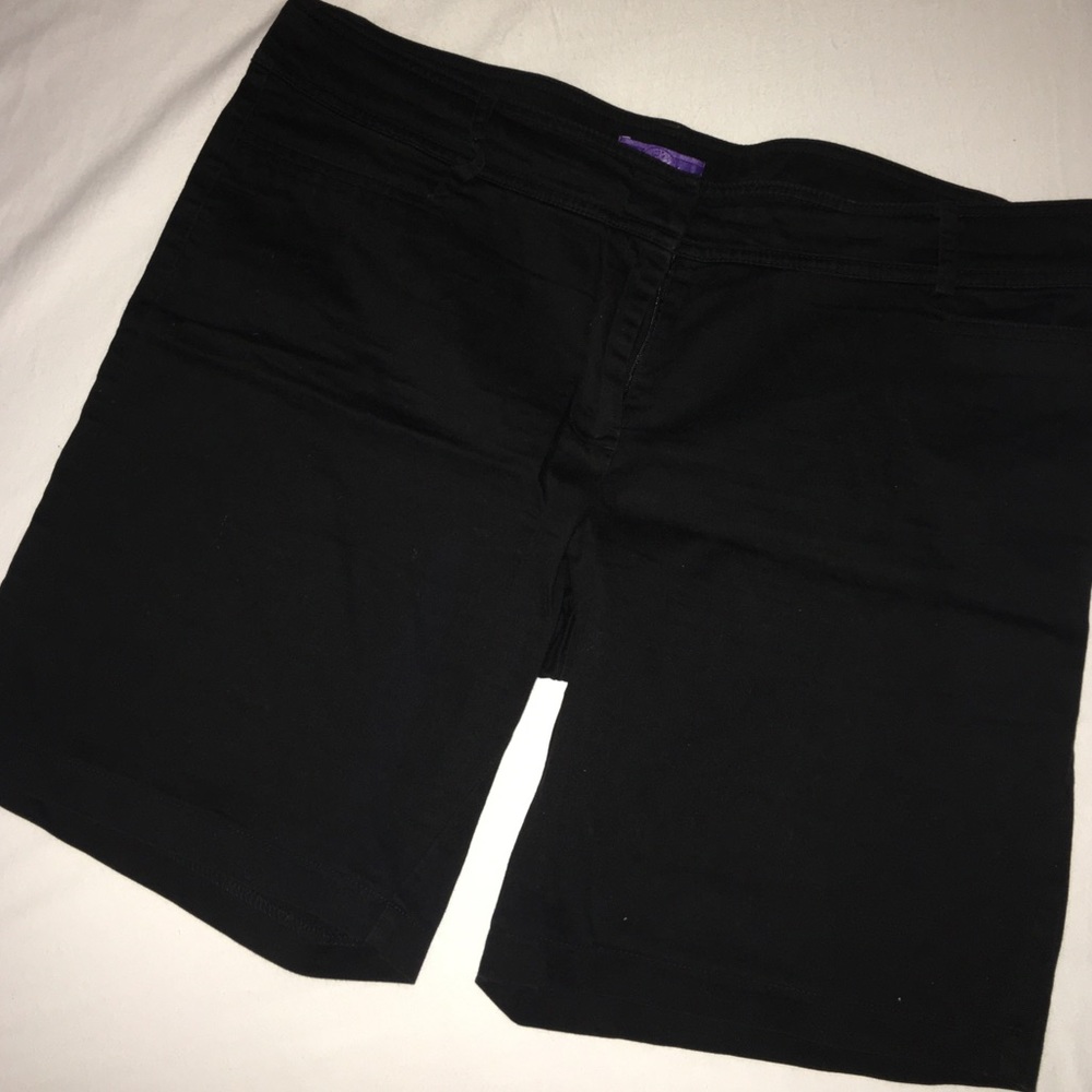Black mid length shorts.
