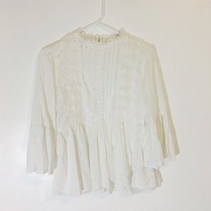 Delicate white top with high neck & bell sleeves