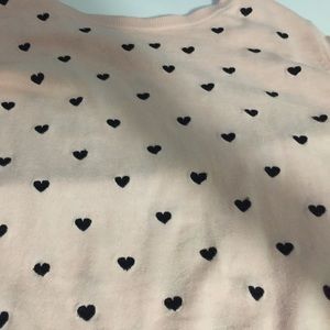 Light pink sweater with black hearts