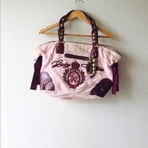 A baby pink Juicy Couture handbag with jewels