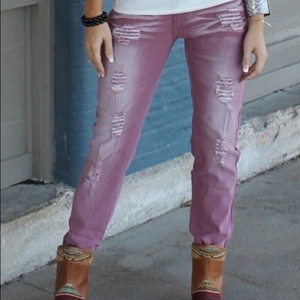 Mauve colored distressed jeans