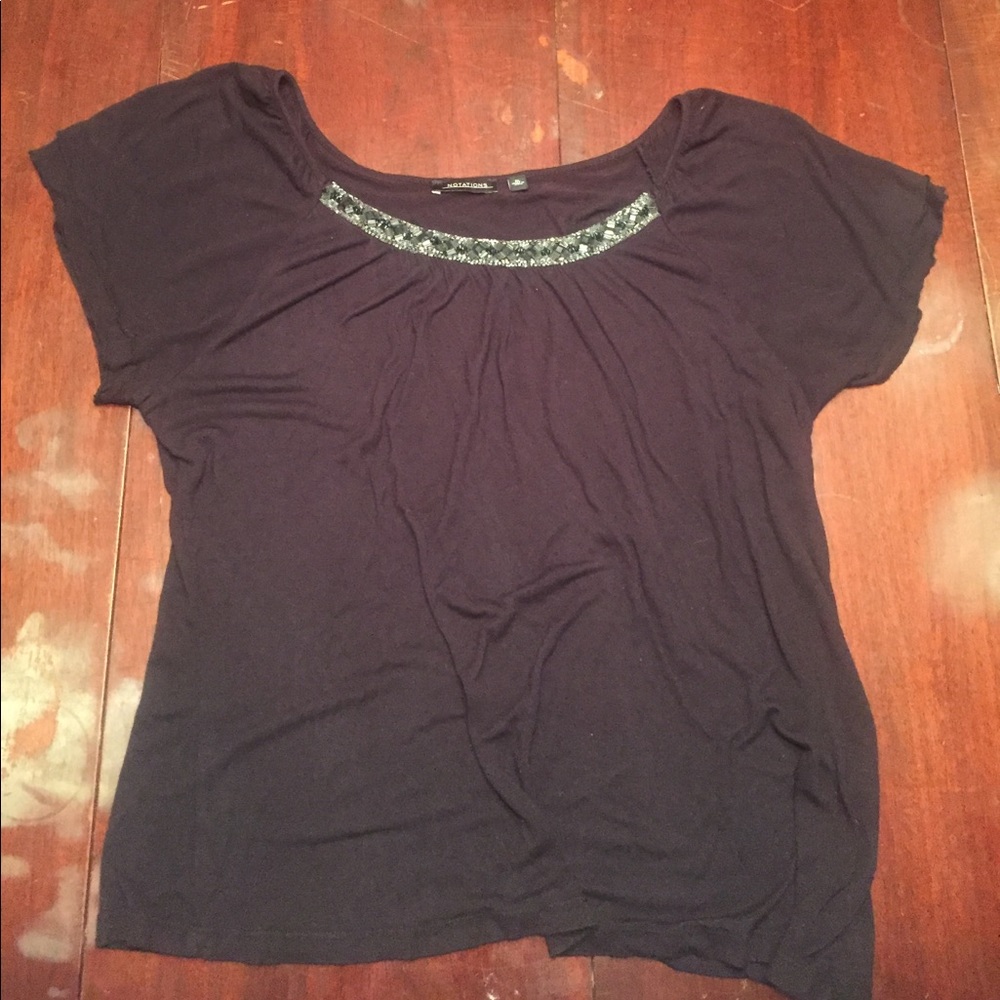 Black top with jewels on the collar.