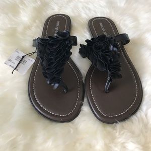 Black frilly flip flops