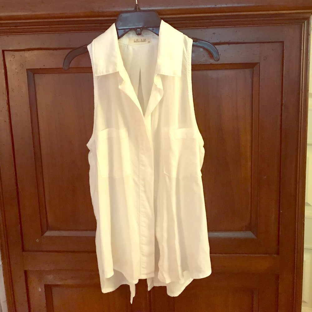 Sleeveless white button-up shirt.