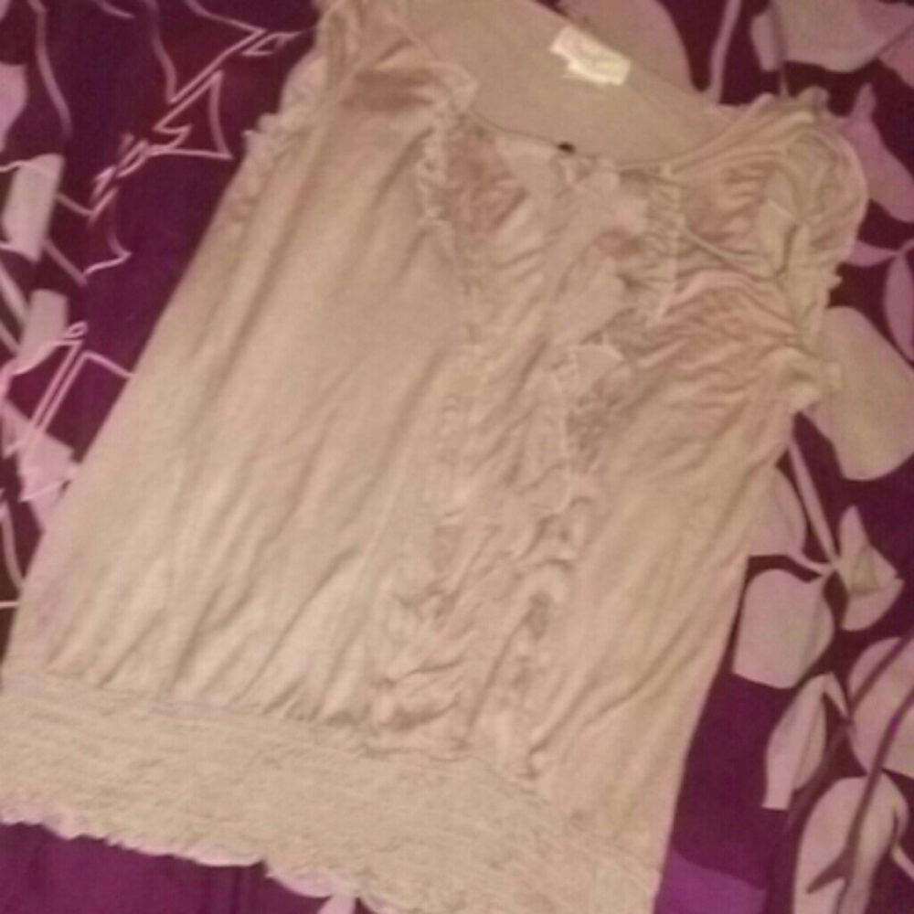 A tan ruffled shirt