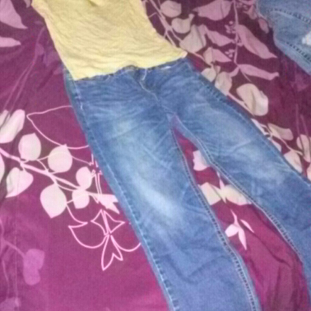 A tan cami with a pair of boot cut jeans