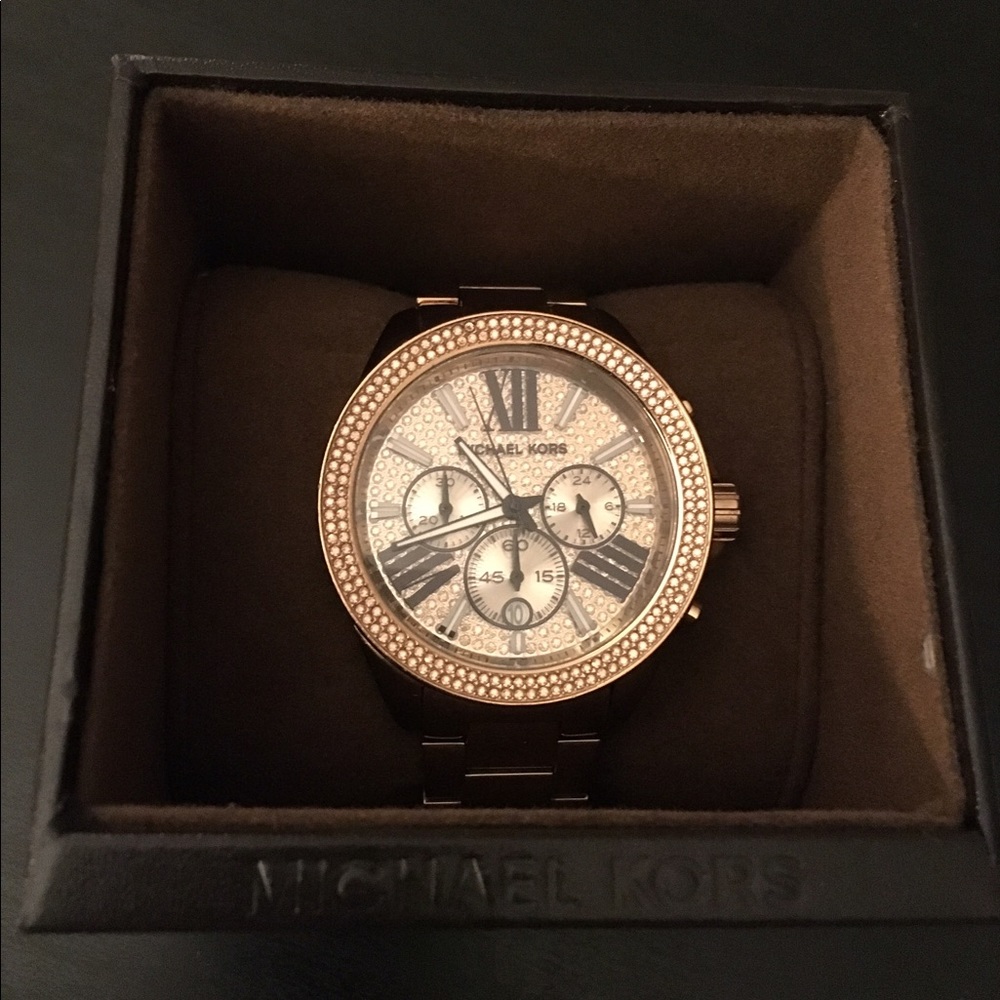 Gold, round face Michael Kors watch.