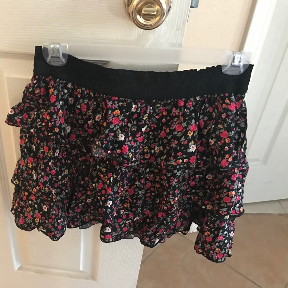 A black mini skirt with floral print