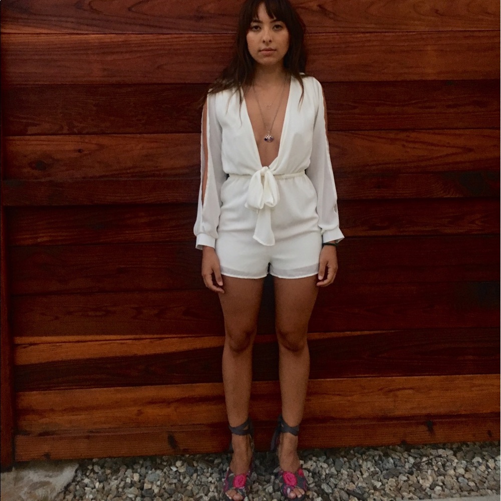 White plunge romper with bow.