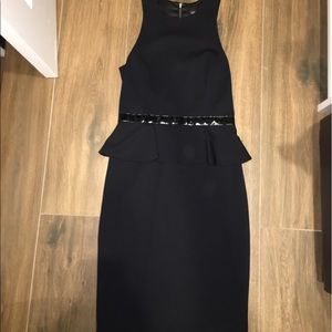 Black peplum dress with zip closure on the back.