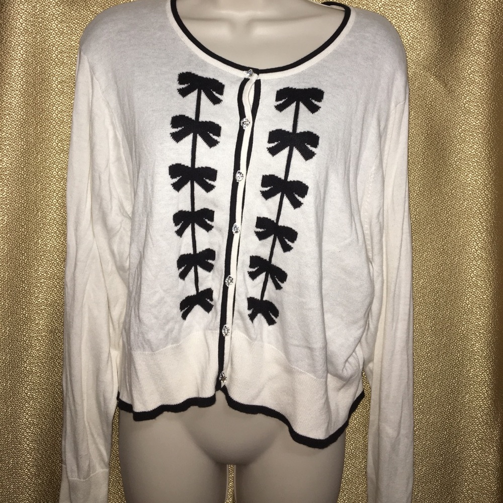 White cardigan with black bows and gem buttons