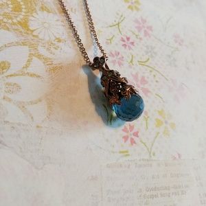Goldish/brass chain with blue pendant