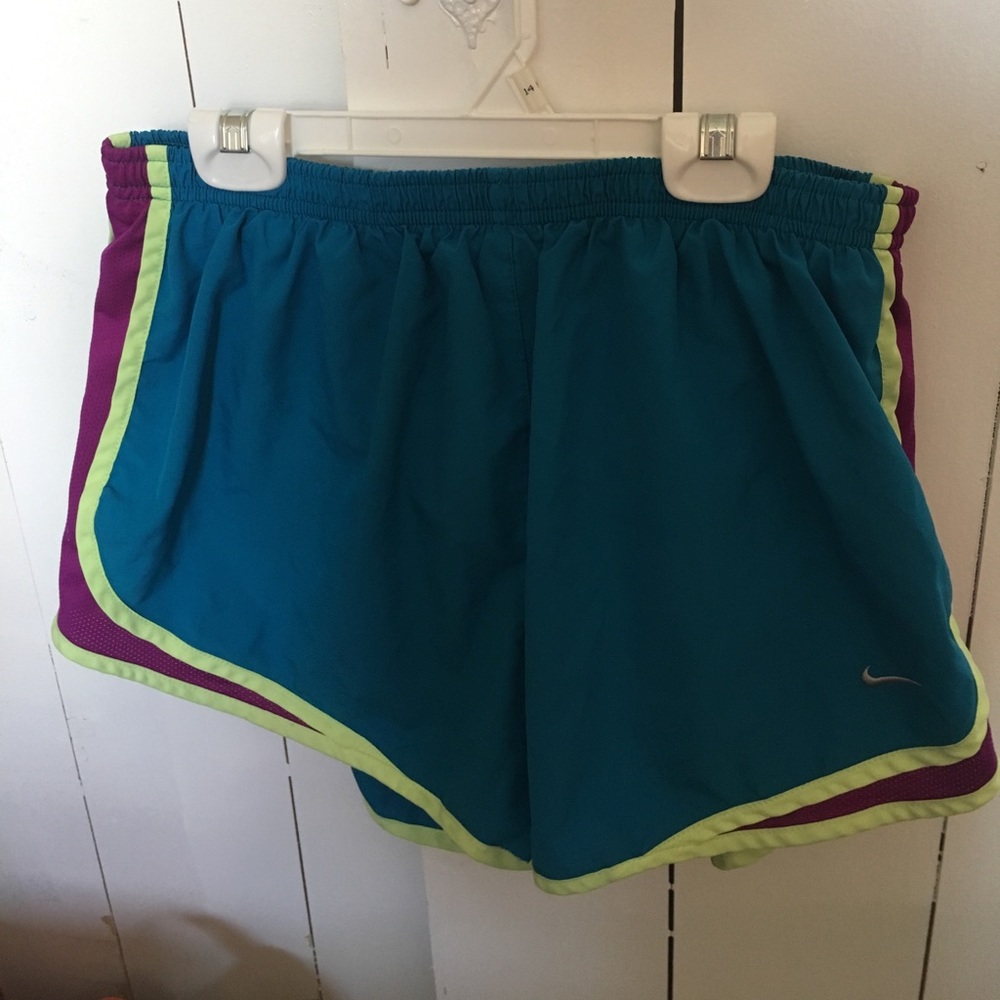 Blue Nike shorts with neon green/purple accents