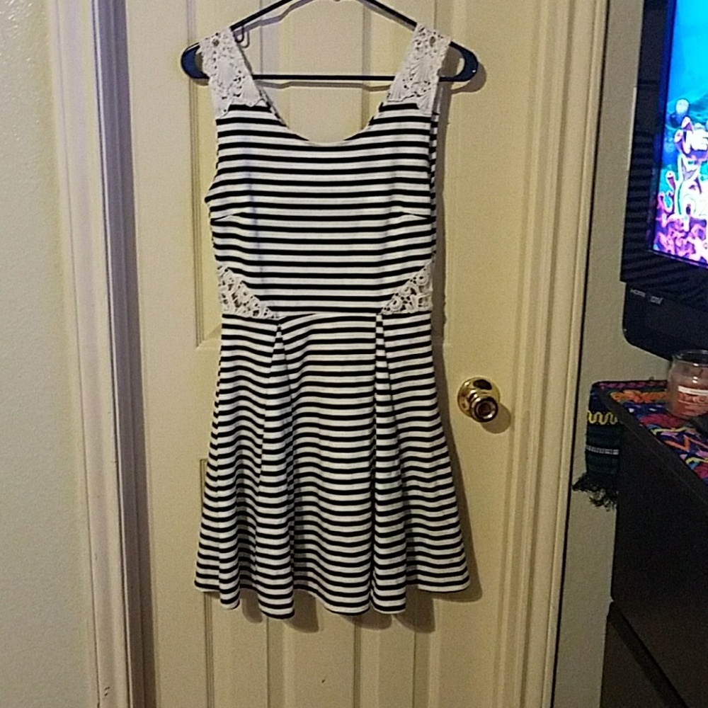 Black and white dress with lace cutouts and straps