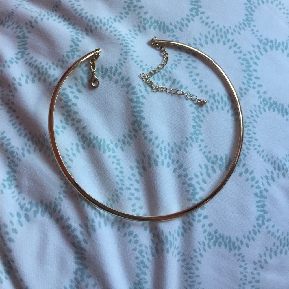gold colored metal necklace