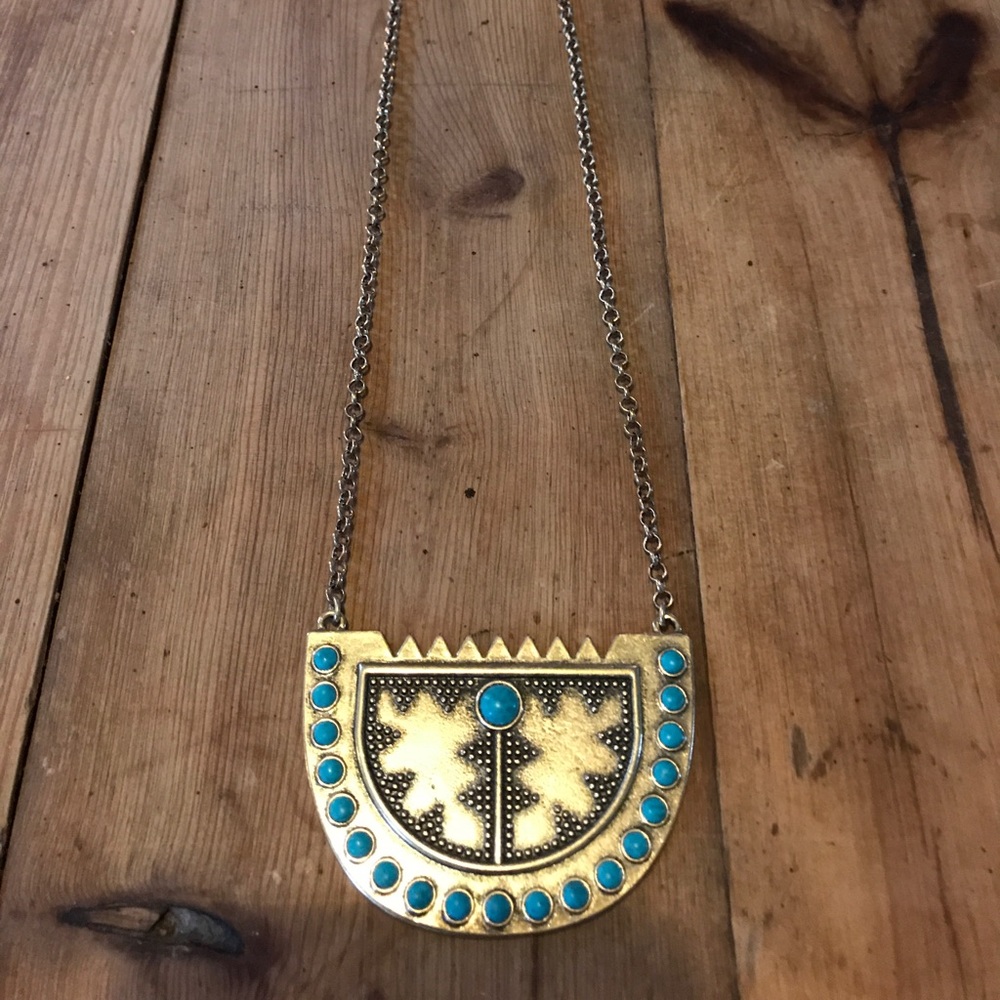 Reversible medallion necklace.