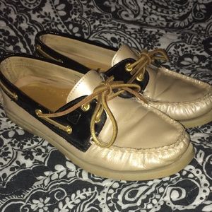 Black and creme colored Sperry's