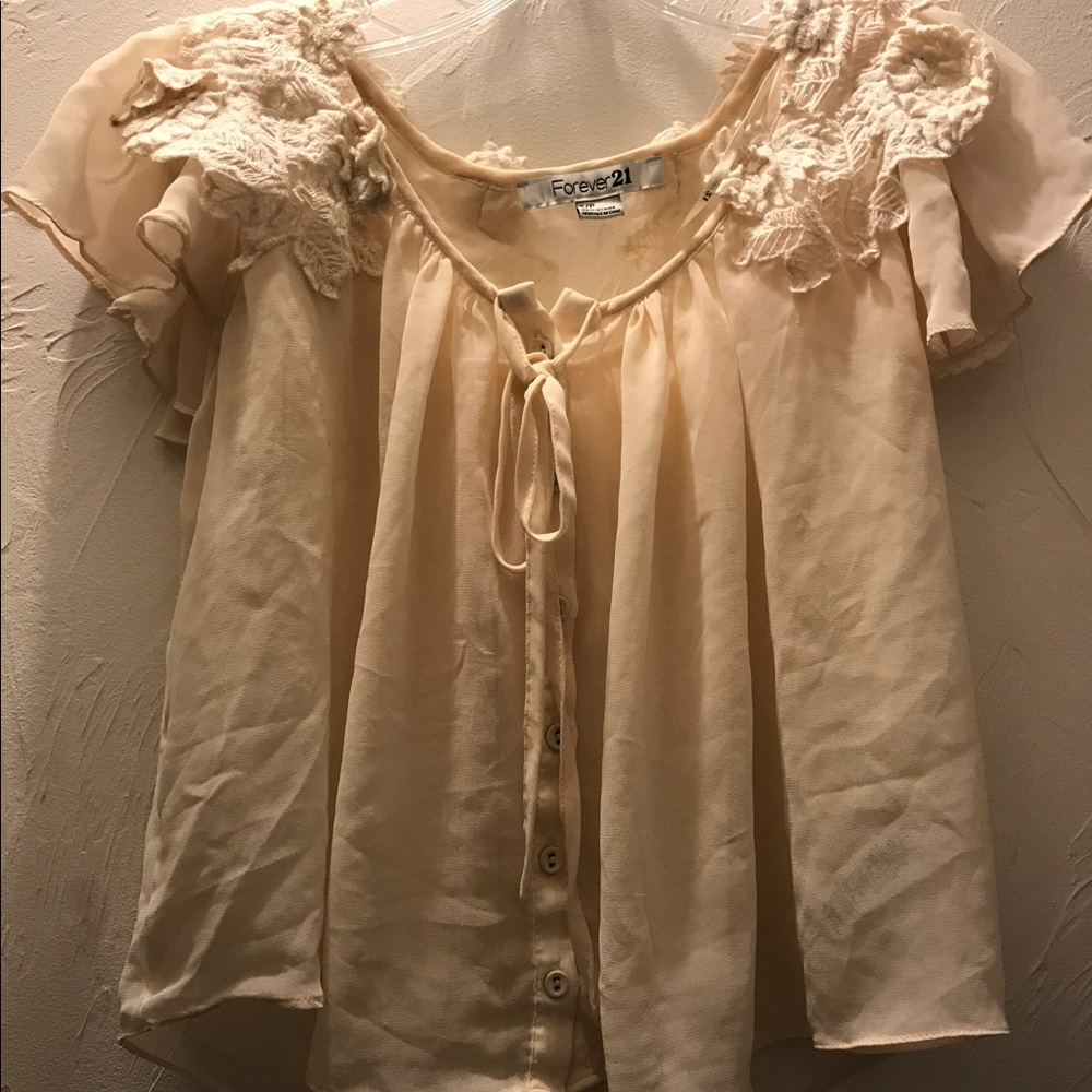 Cream colored lace top. A little short.