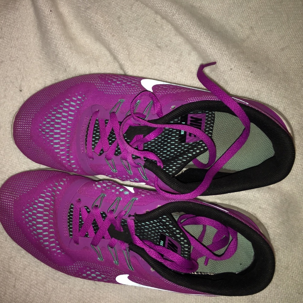 Purple and teal Nike free runs