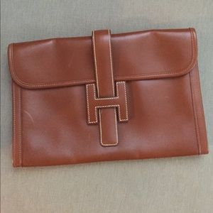 Authentic Hermes brown clutch with dust bag.