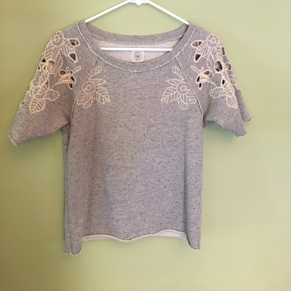 Sweatshirt material top with open stitching.