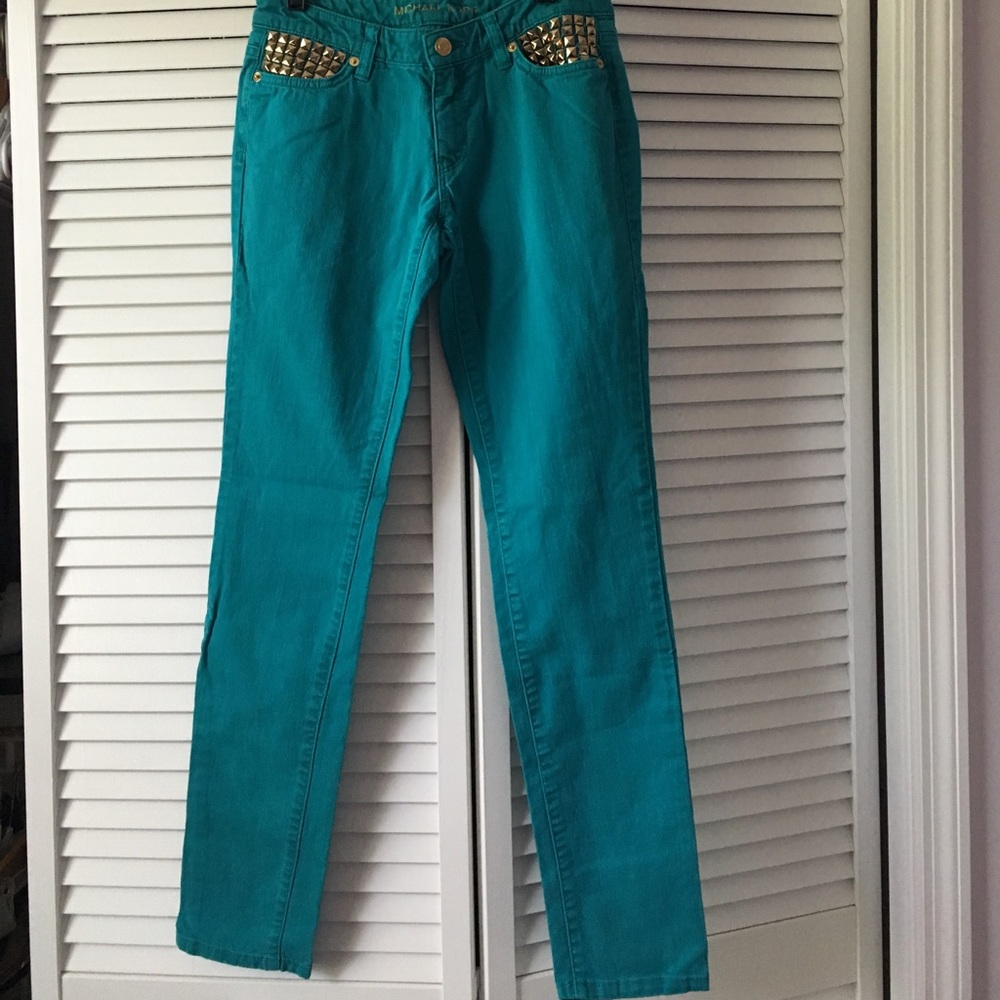 MK teal-colored skinny jeans with gold studs!