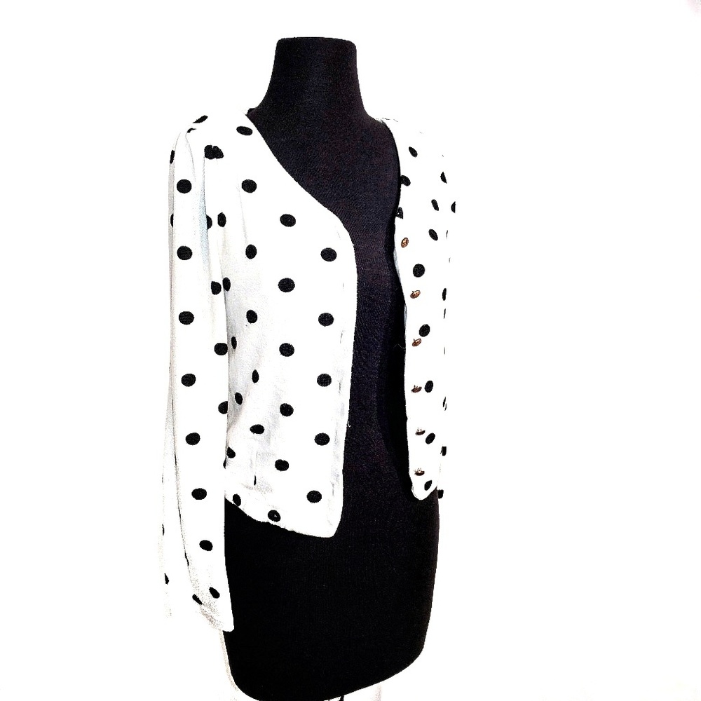 White and black cardigan with gold buttons.