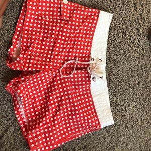 Orange/white polka dot board shorts.