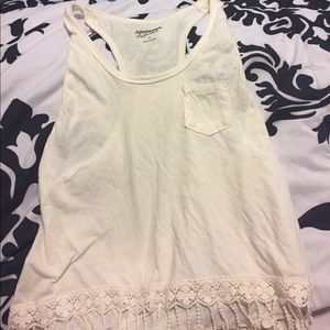 Off white tank with fringe at bottom