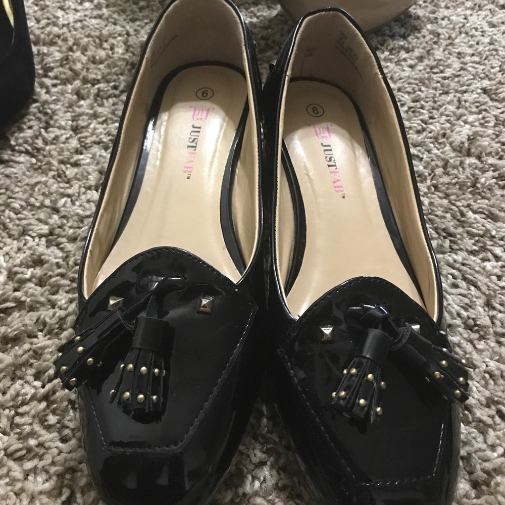 Black loafers with gold studded accents