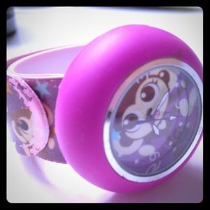 A slap clock watch with monkeys on it