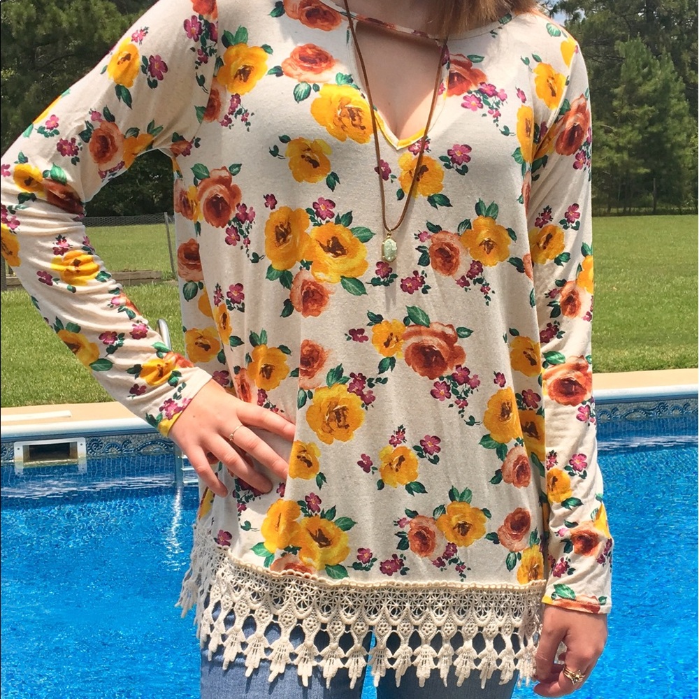 Cream floral top with a crocheted hem