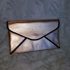 Gold clutch with Black pipping