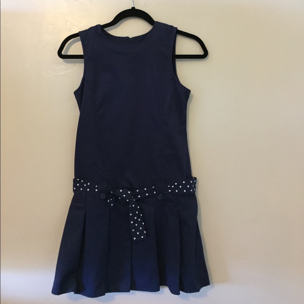 Navy girls dress with polka-dotted belt.