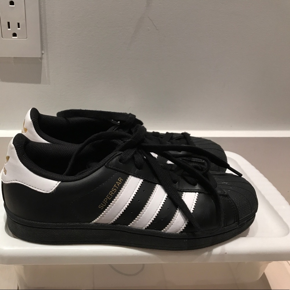 black and white adidas superstars.
