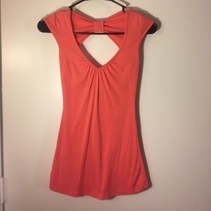 Salmon colored top with cutout in back