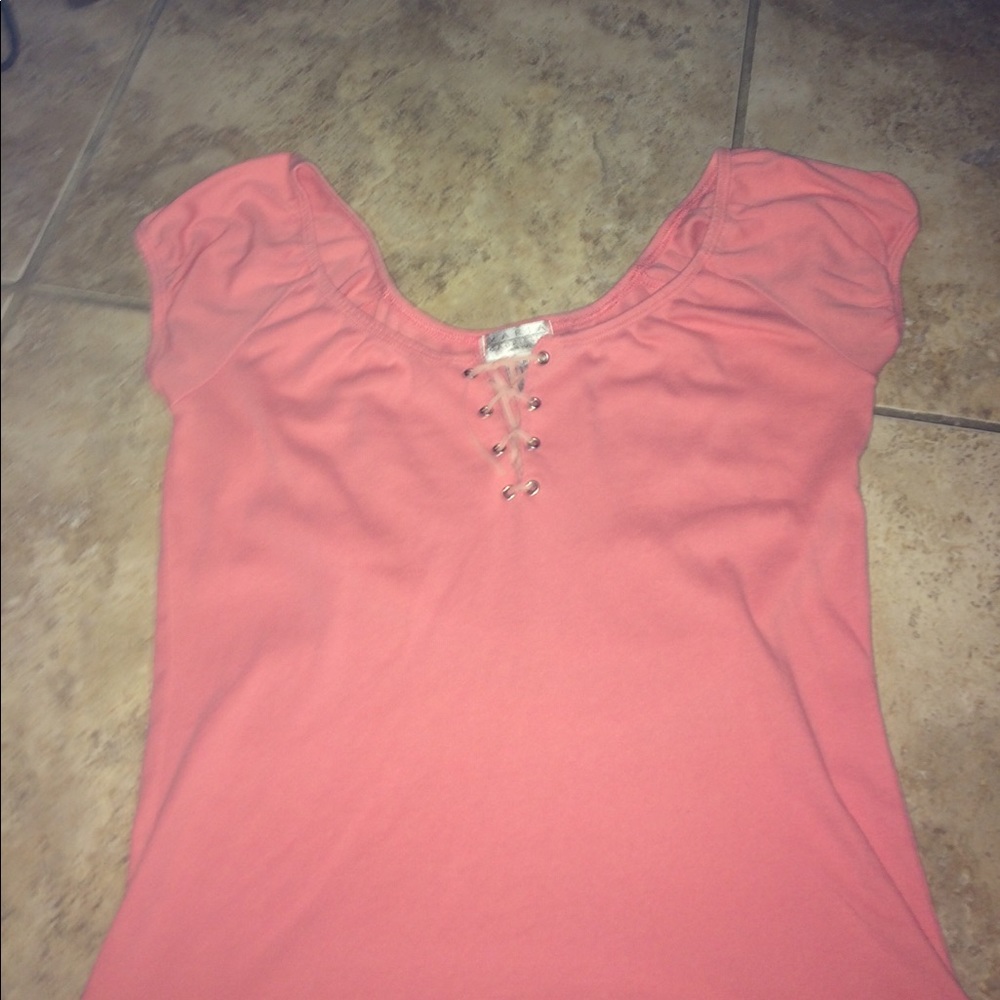 pretty pink shirt hangs on shoulders tied front