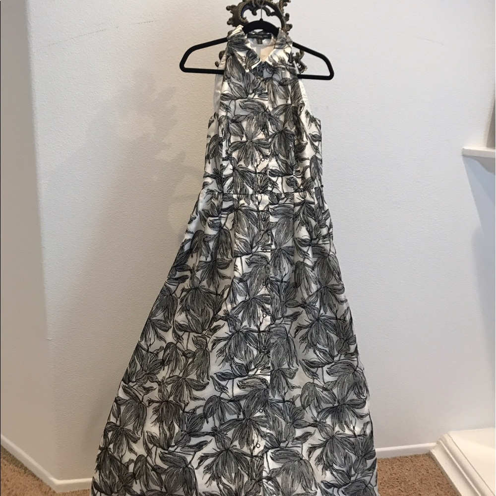 White gown with black embroidery.