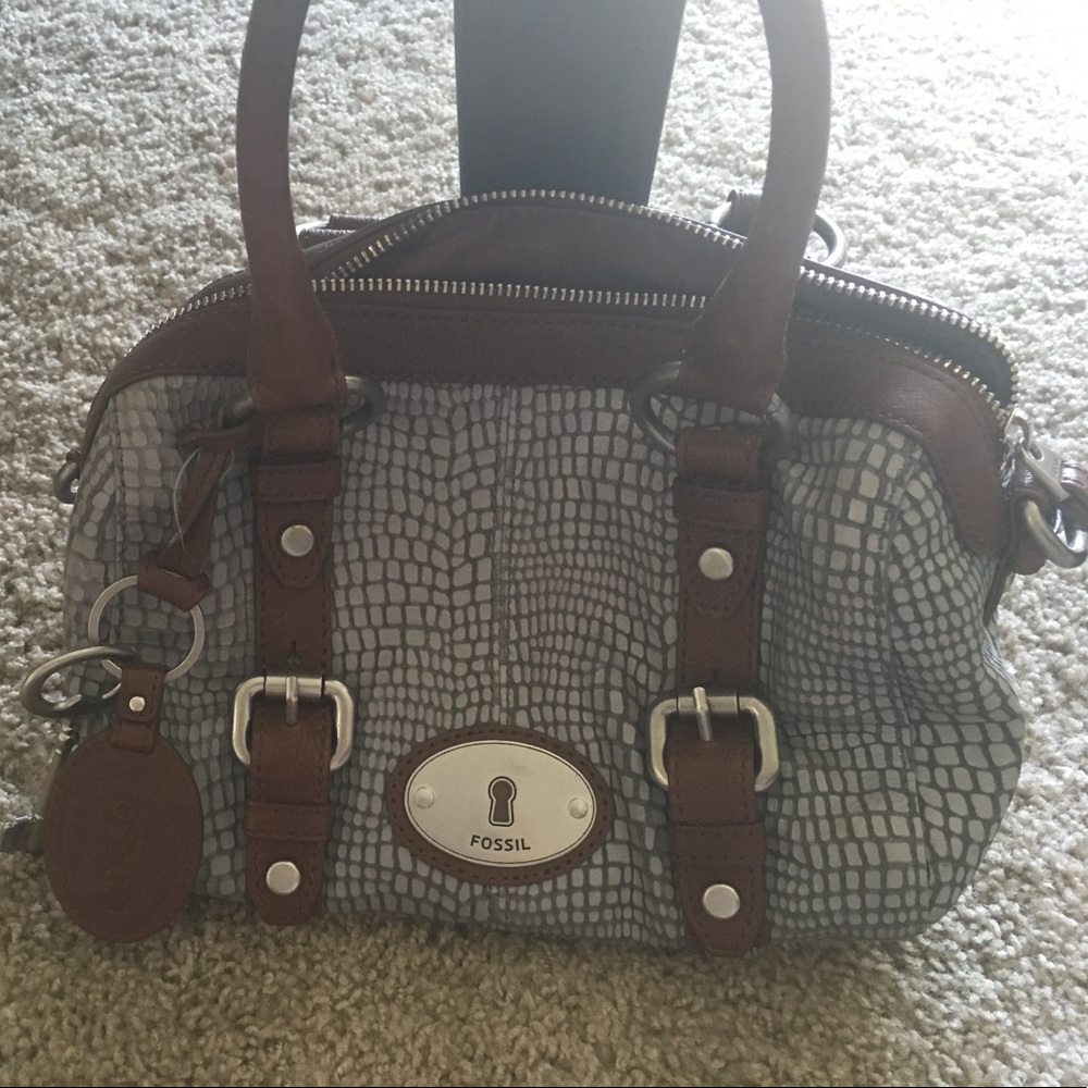 Fossil hand bag with strap.