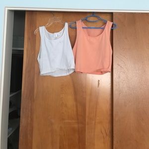 White and Orange BP crop tank tops.