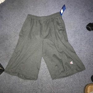 Dark gray champion shorts with pockets.