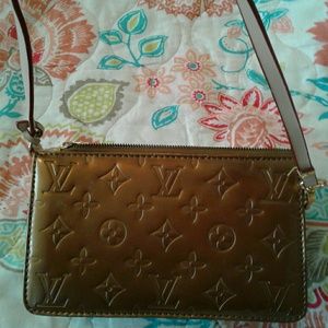 Louis Vuitton gold clutch.