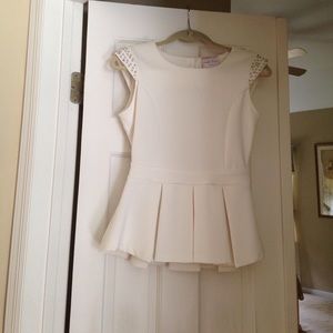 Beige peplum top wit silver studs.