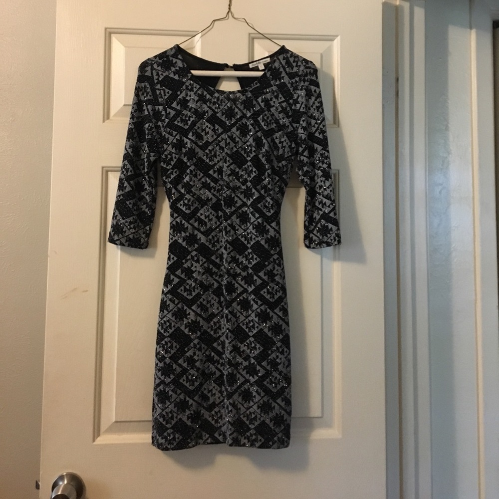 A black and silver, sparkly, tight fit dress.