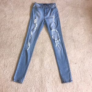 Ripped light wash fitted jeans from Fashion Nova