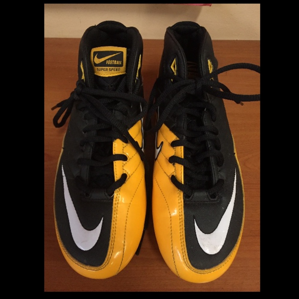 Black and yellow Nike football super speed cleats
