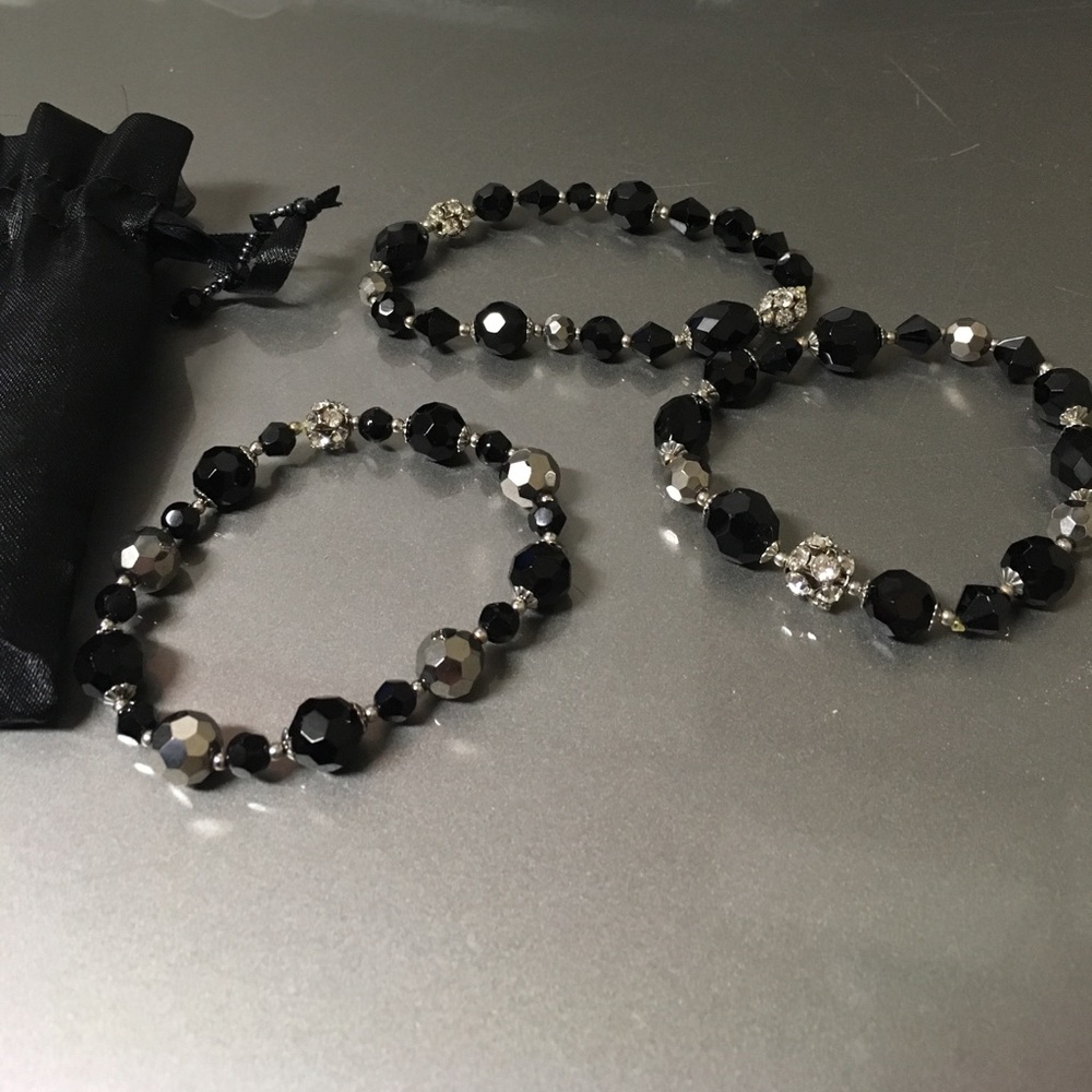 Set of three black and faux diamond bracelets