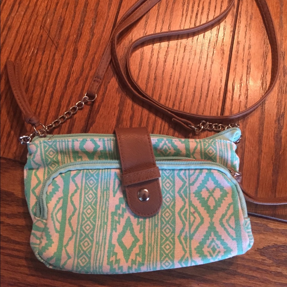 I'm selling a teal and white cross body bag.