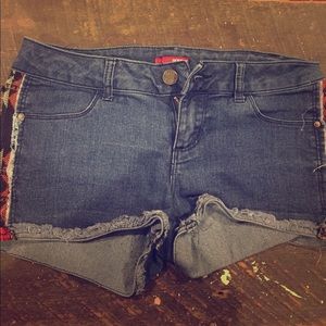 I'm selling denim shorts with tribal patterns.