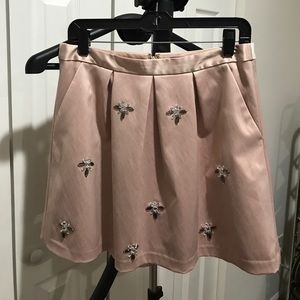 Soft pink, pleated skirt with gem accents